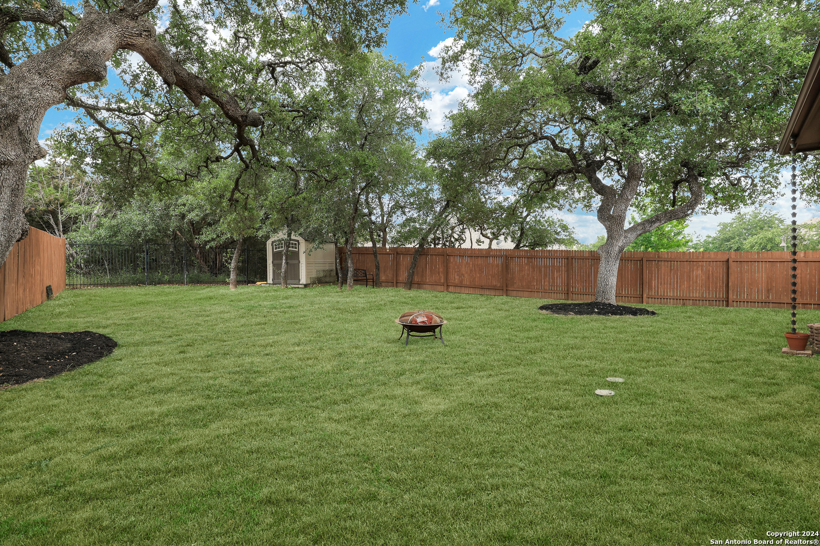 28565 Willis Ranch San Antonio, TX 78260 - Photo 38 of 39 a view of a backyard with a garden and trees