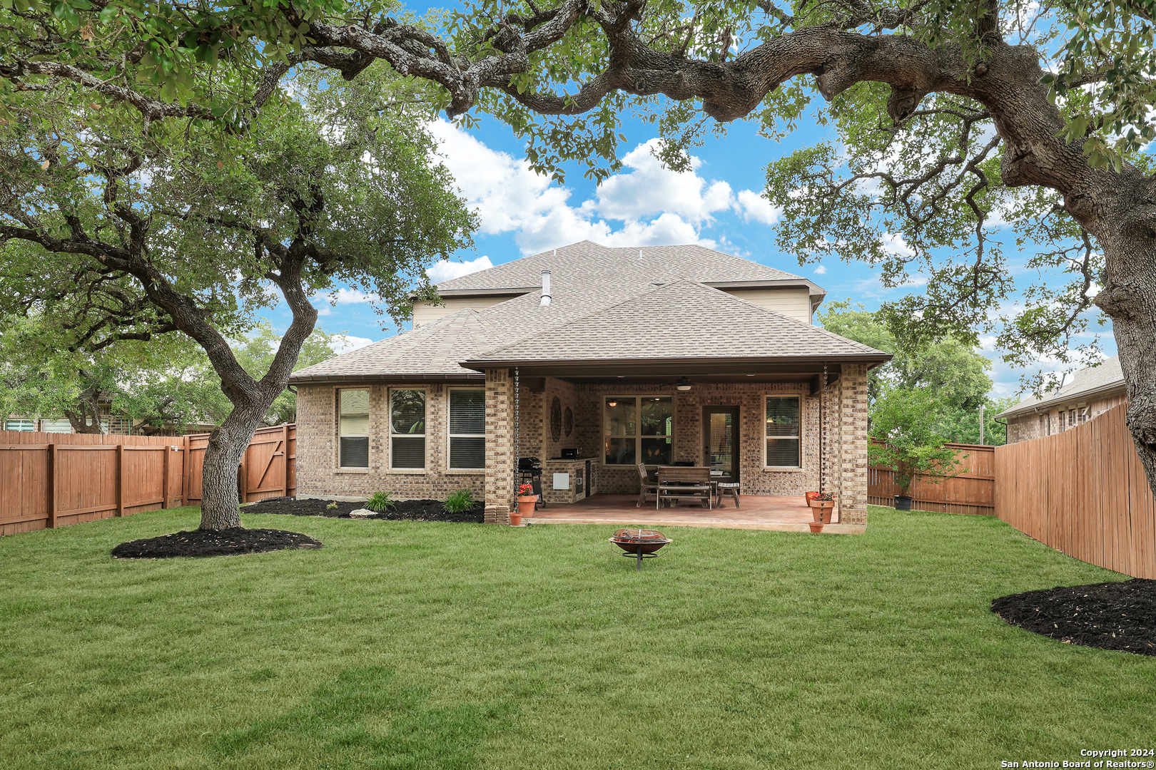 28565 Willis Ranch San Antonio, TX 78260 - Photo 39 of 39 a front view of a house with a garden and trees