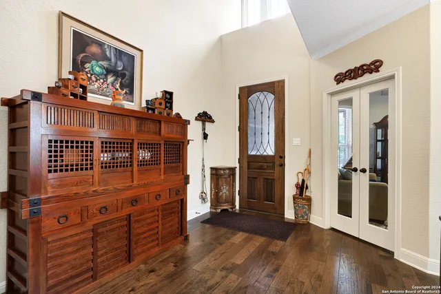 a view of a hallway with wooden floor and windows