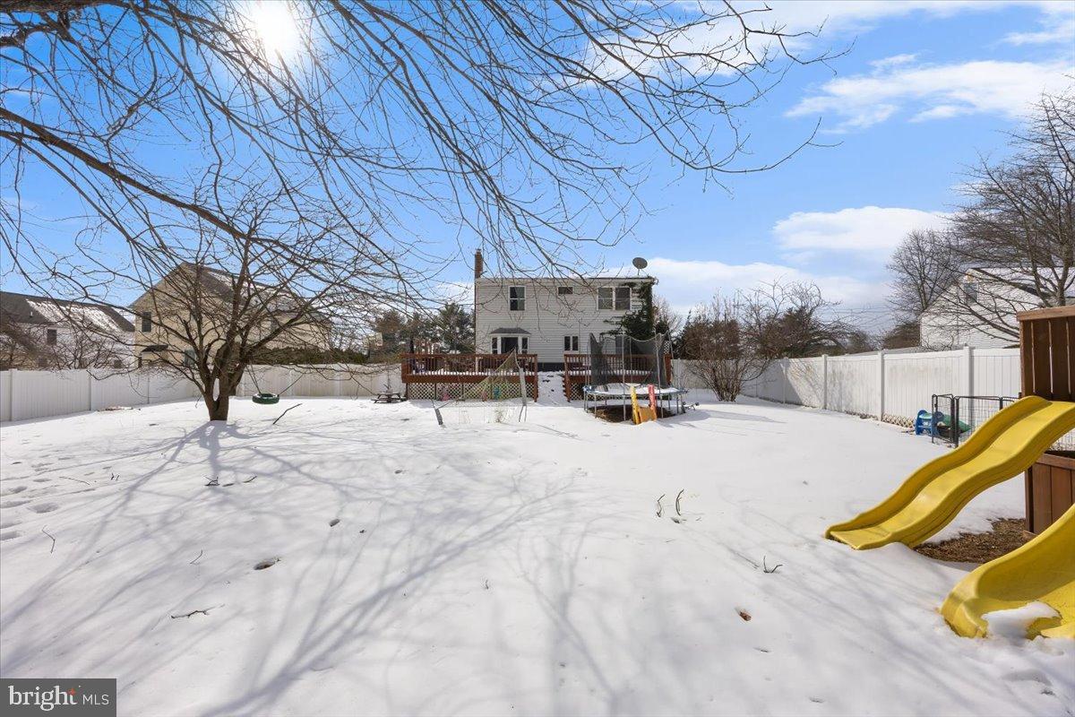 2414 Church Road Cinnaminson, NJ 08077 - Photo 37 of 41 Snowy backyard with playful slide and trees.