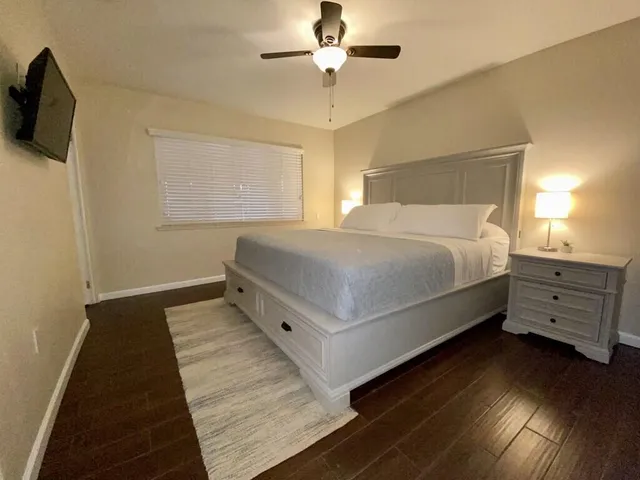 a bedroom with a bed and flat screen tv