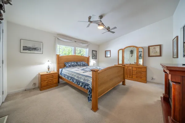 an empty room with a ceiling fan and a window