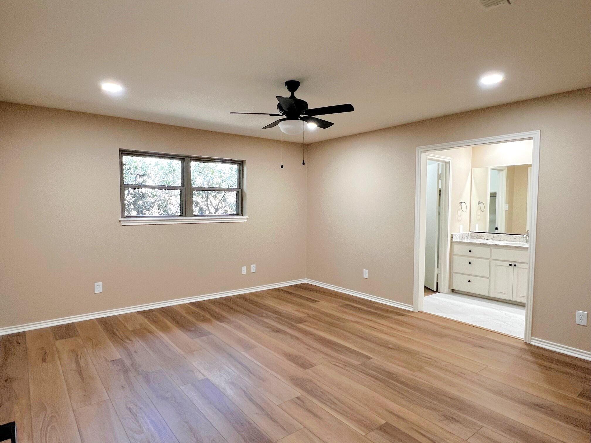 3506 86th Street Lubbock, TX 79423 - Photo 12 of 29 wooden floor in an empty room with a window