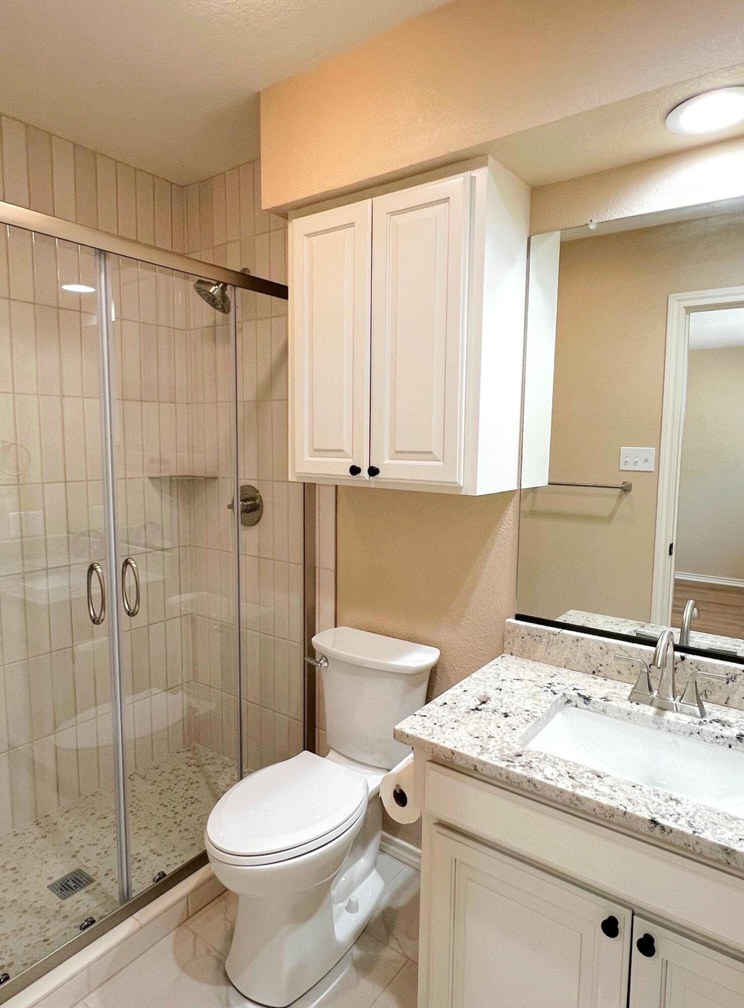 3506 86th Street Lubbock, TX 79423 - Photo 21 of 29 a bathroom with a granite countertop sink toilet and shower