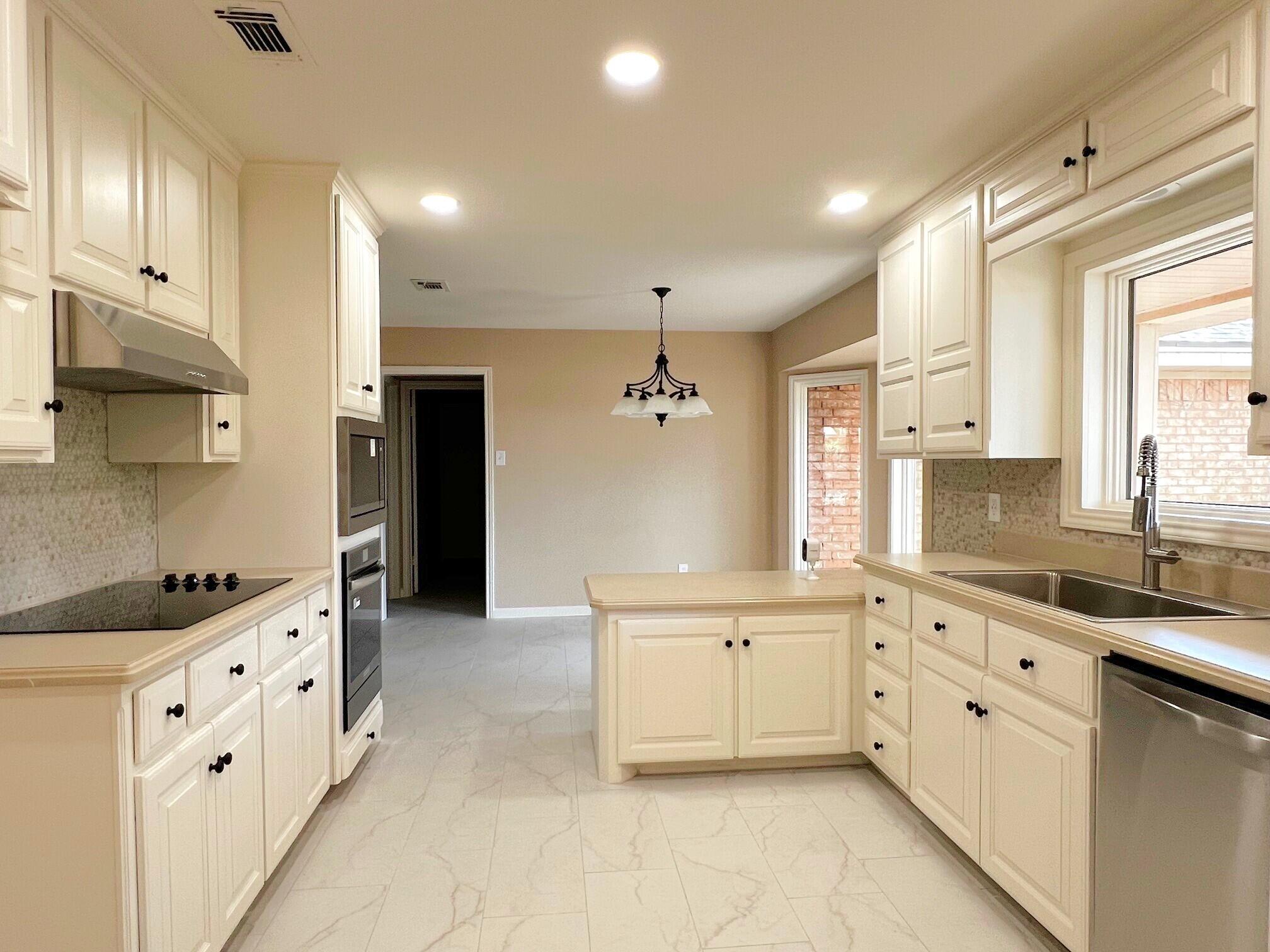 3506 86th Street Lubbock, TX 79423 - Photo 3 of 29 a large kitchen with stainless steel appliances kitchen island granite countertop a sink and cabinets