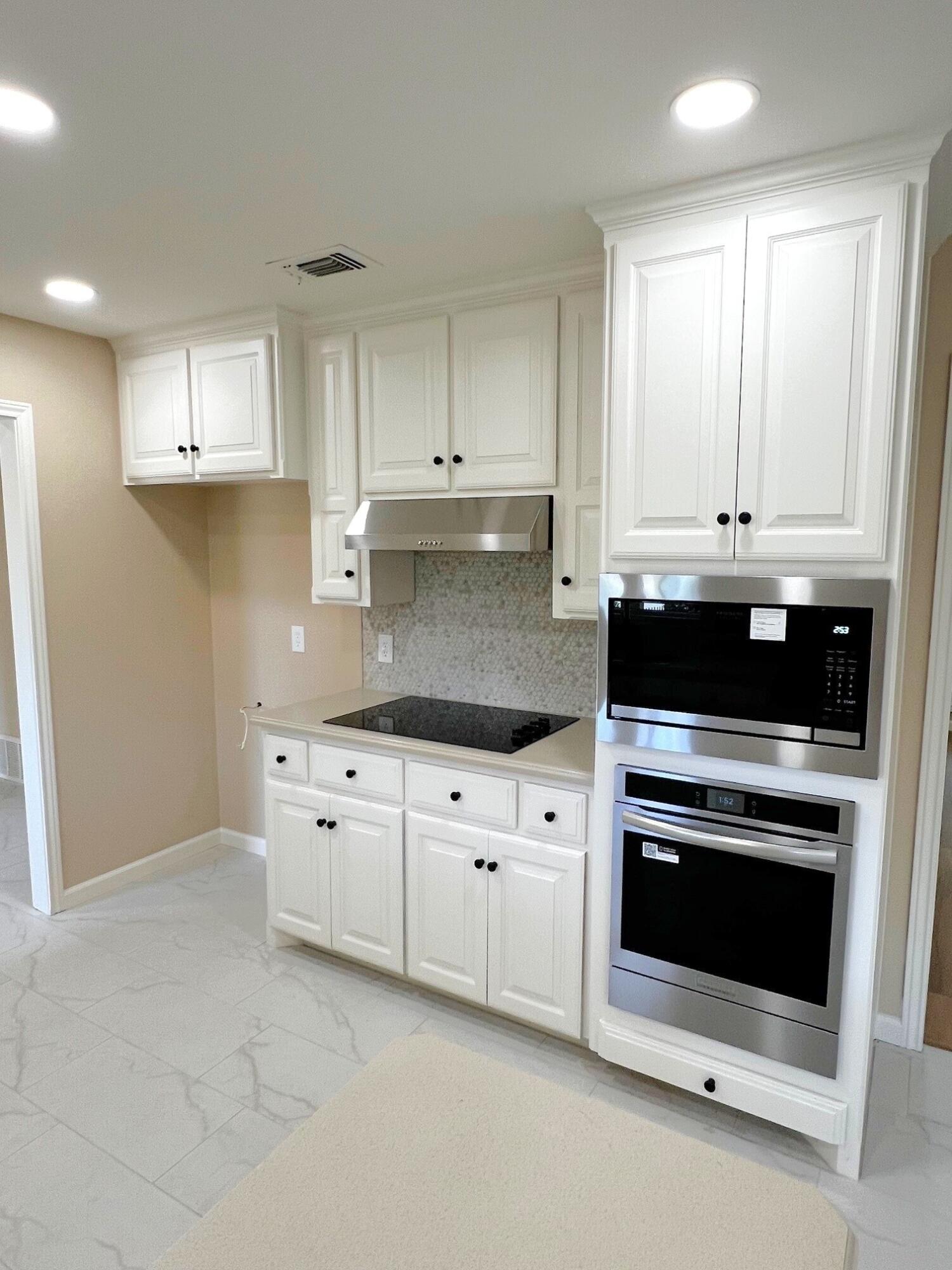3506 86th Street Lubbock, TX 79423 - Photo 6 of 29 a kitchen with granite countertop white cabinets and stainless steel appliances