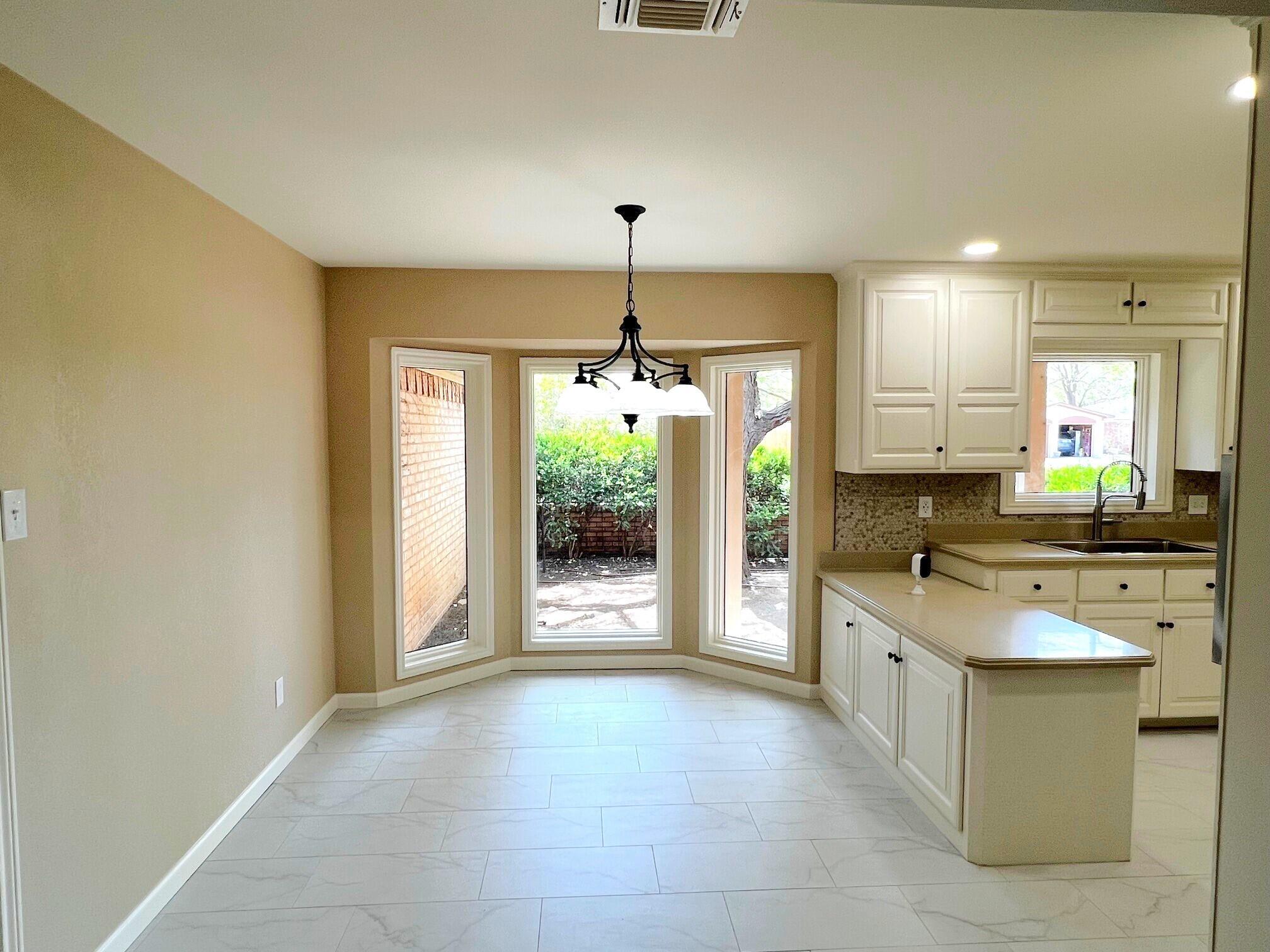 3506 86th Street Lubbock, TX 79423 - Photo 8 of 29 a kitchen with stainless steel appliances granite countertop a stove a sink and a refrigerator