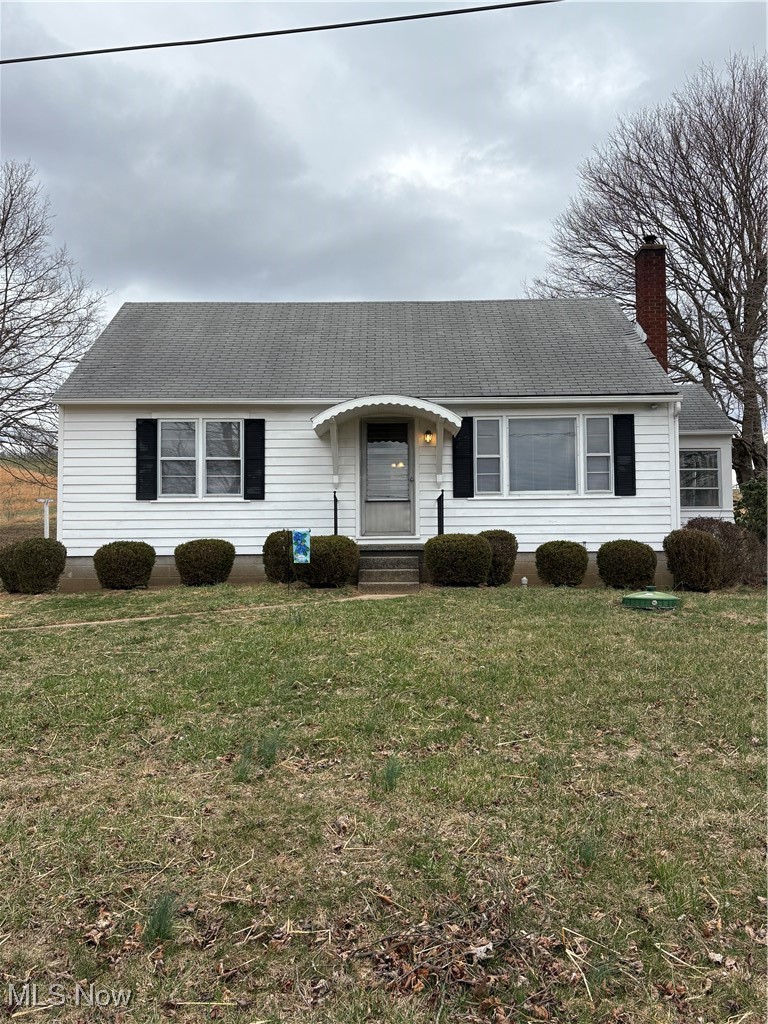 9801 Clay Pike Road Byesville, OH 43723 - Photo 9 of 27 Ranch-style house with roof with shingles, a front lawn, and a chimney