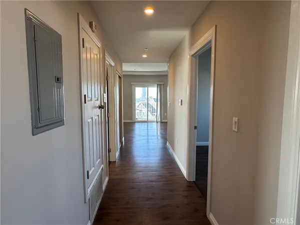 a view of a hallway with wooden floor
