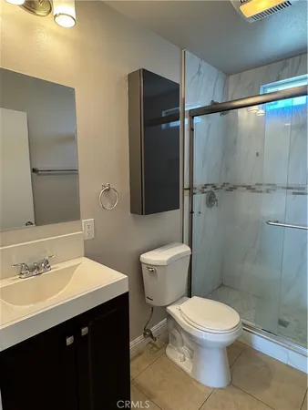 a bathroom with a toilet a sink and shower