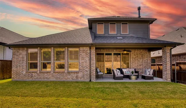 a view of a house with swimming pool and furniture