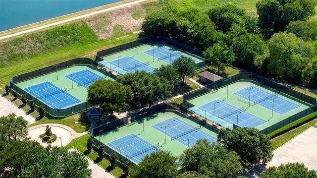 an aerial view of a tennis ground and a yard