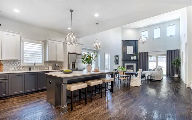 a large kitchen with a table and chairs