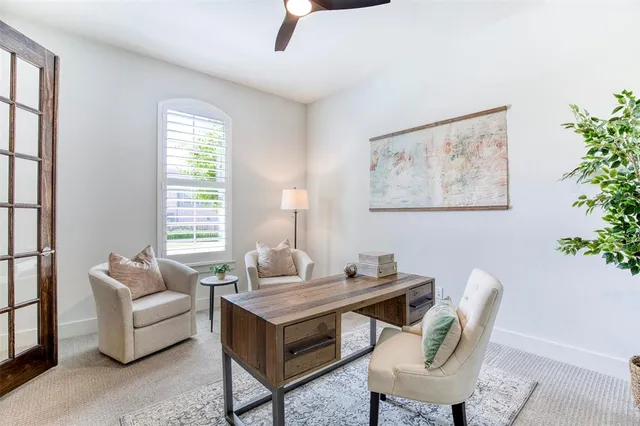 a living room with furniture and a potted plant