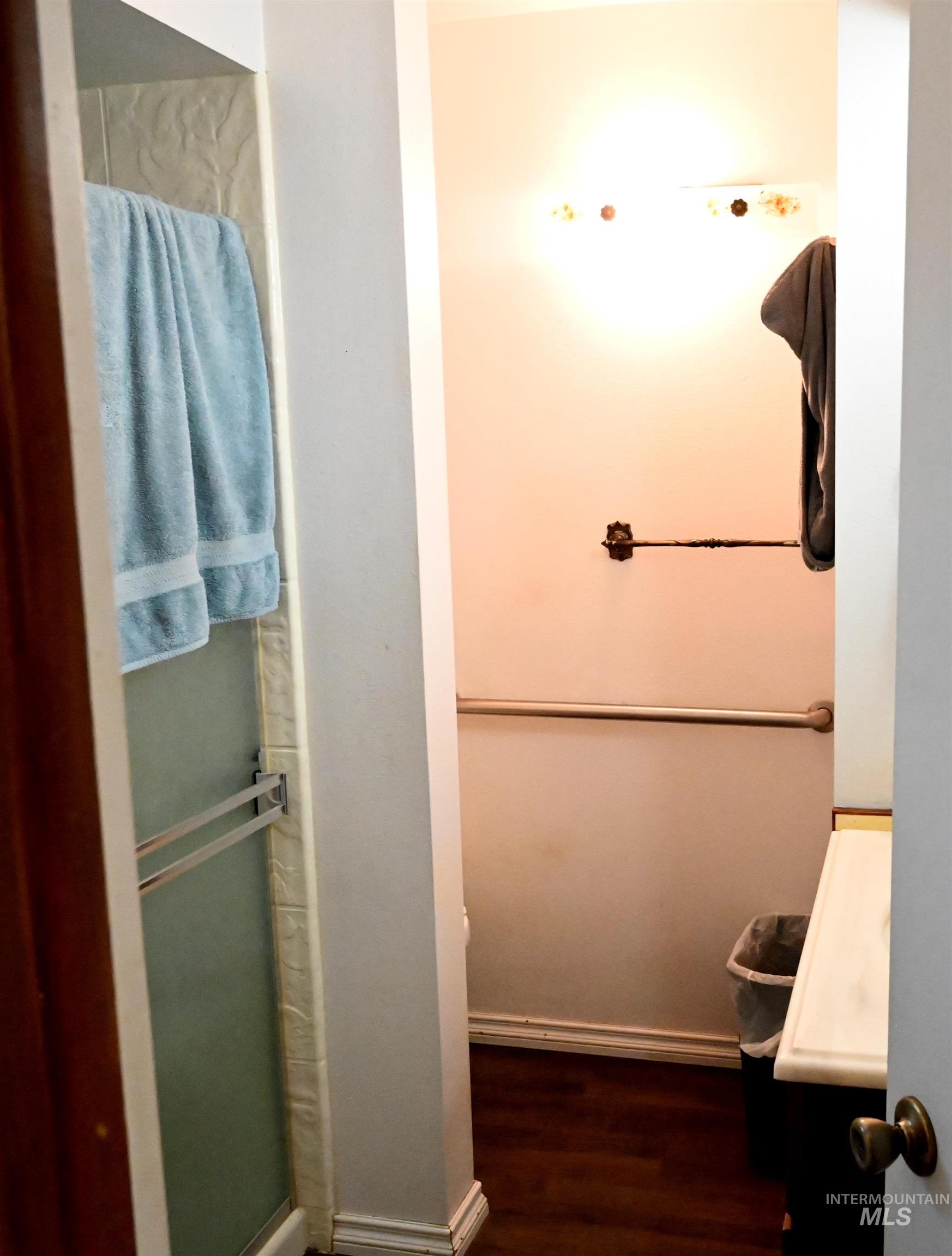 646 Riverside Avenue Orofino, ID 83544 - Photo 7 of 23 Bathroom with a shower stall, vanity, and dark wood-type flooring