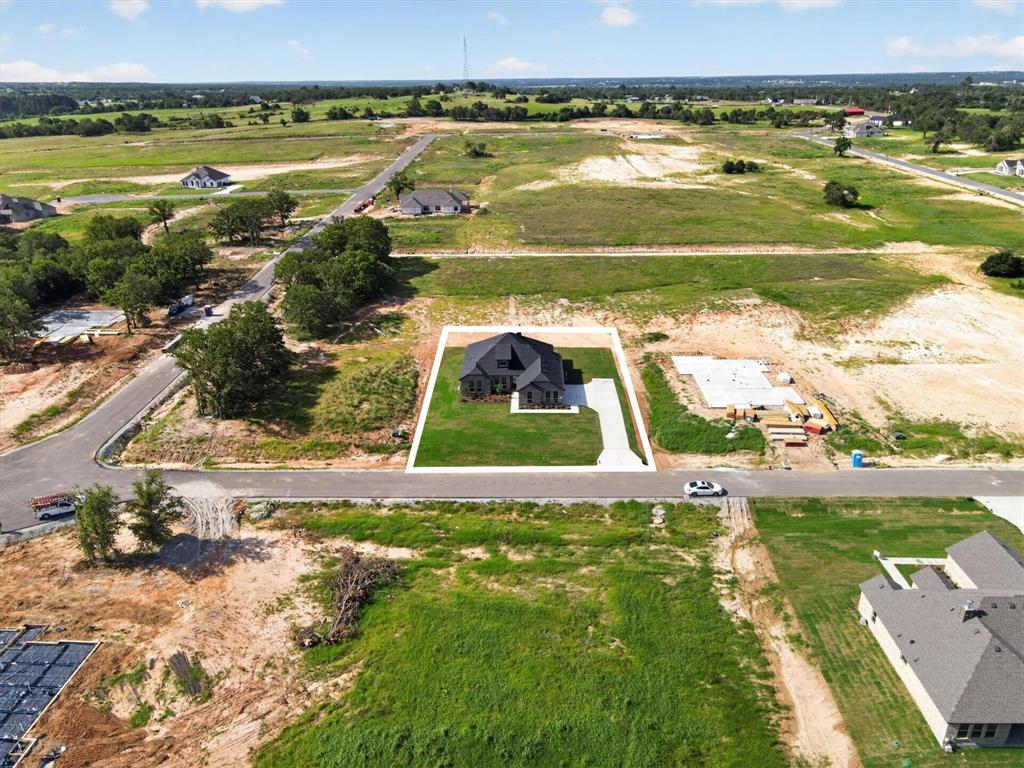 416 McAlpine Drive Springtown, TX 76082 - Photo 38 of 40 Newly constructed residence with a dark gray roof, situated on a verdant lot