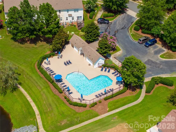 an aerial view of a house with a garden and swimming pool