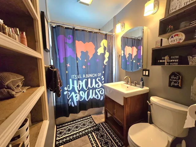 a bathroom with a toilet a sink and a shower