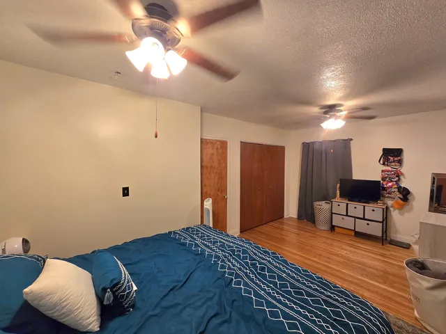 a bedroom with a bed and a chandelier