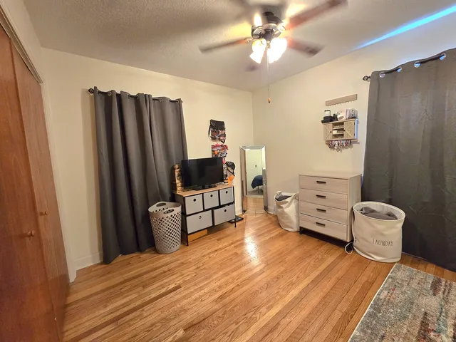 a bedroom with furniture and a flat screen tv