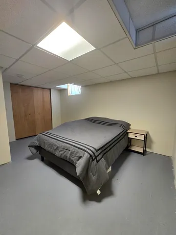a bedroom with a bed and a cabinets