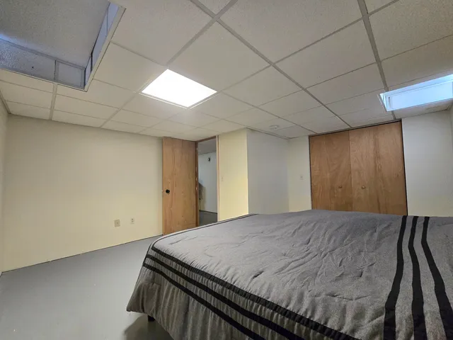 a bed in a room next to a window