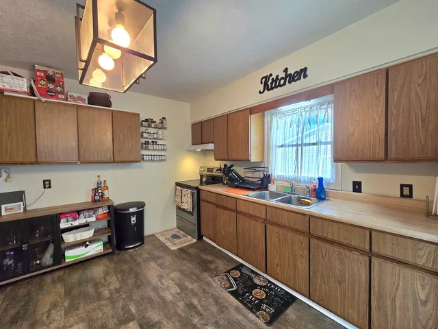 a kitchen that has a sink and a stove in it