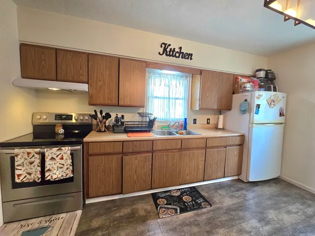 a kitchen with sink cabinets and window