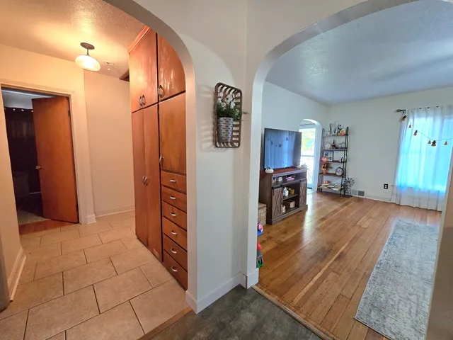 a view of a hallway view with wooden floor and staircase