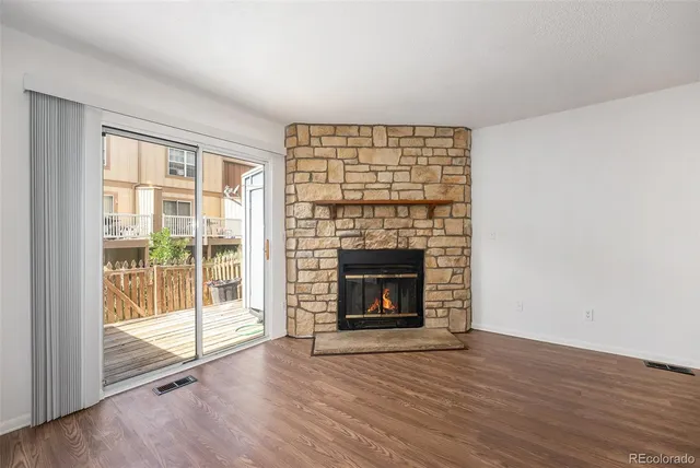 a view of a livingroom with wooden floor and stairs