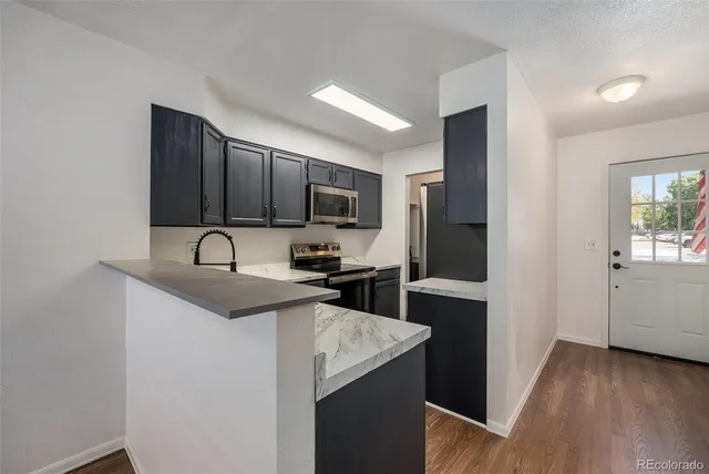 a kitchen with a sink stove and microwave