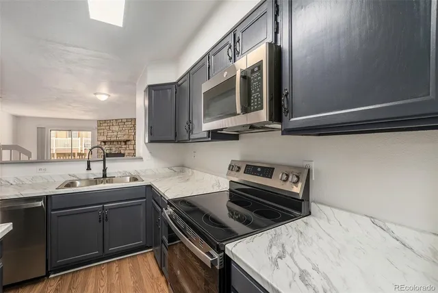 a kitchen with a sink stove and microwave