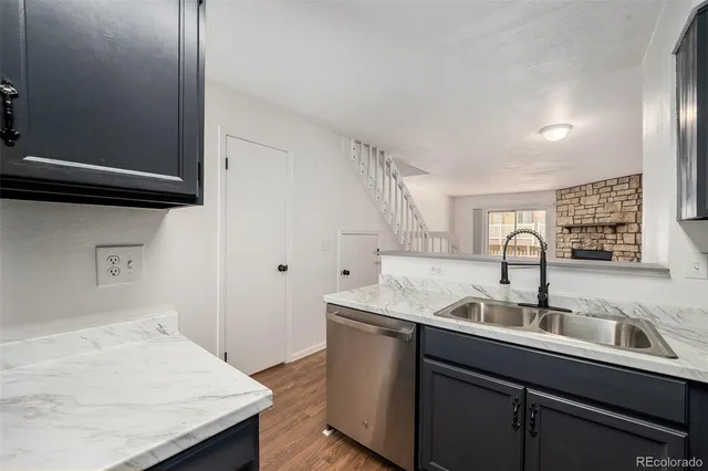 a kitchen that has a sink and a stove in it