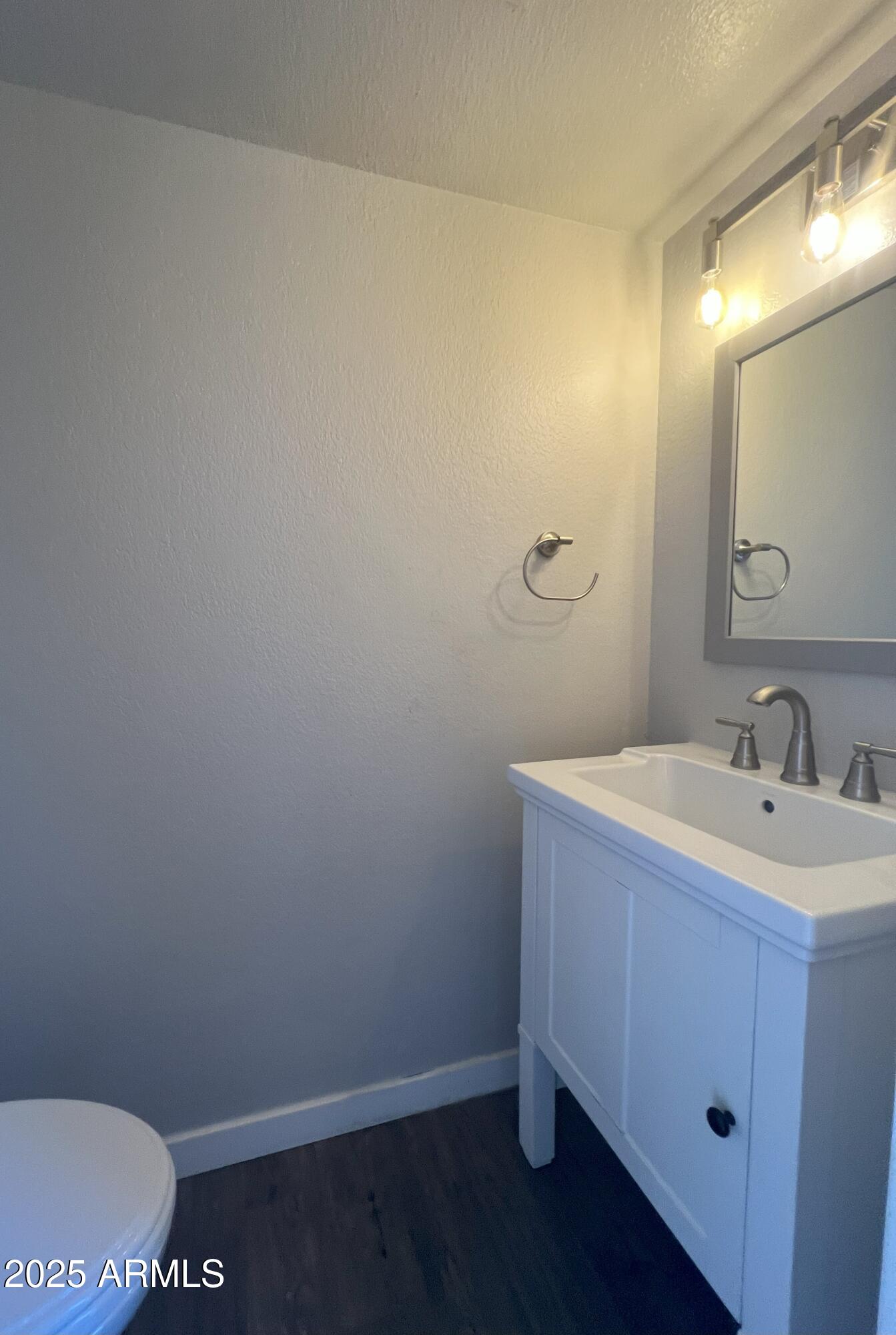 4011 East Charter Oak Road Phoenix, AZ 85032 - Photo 12 of 31 a bathroom with a sink and a mirror