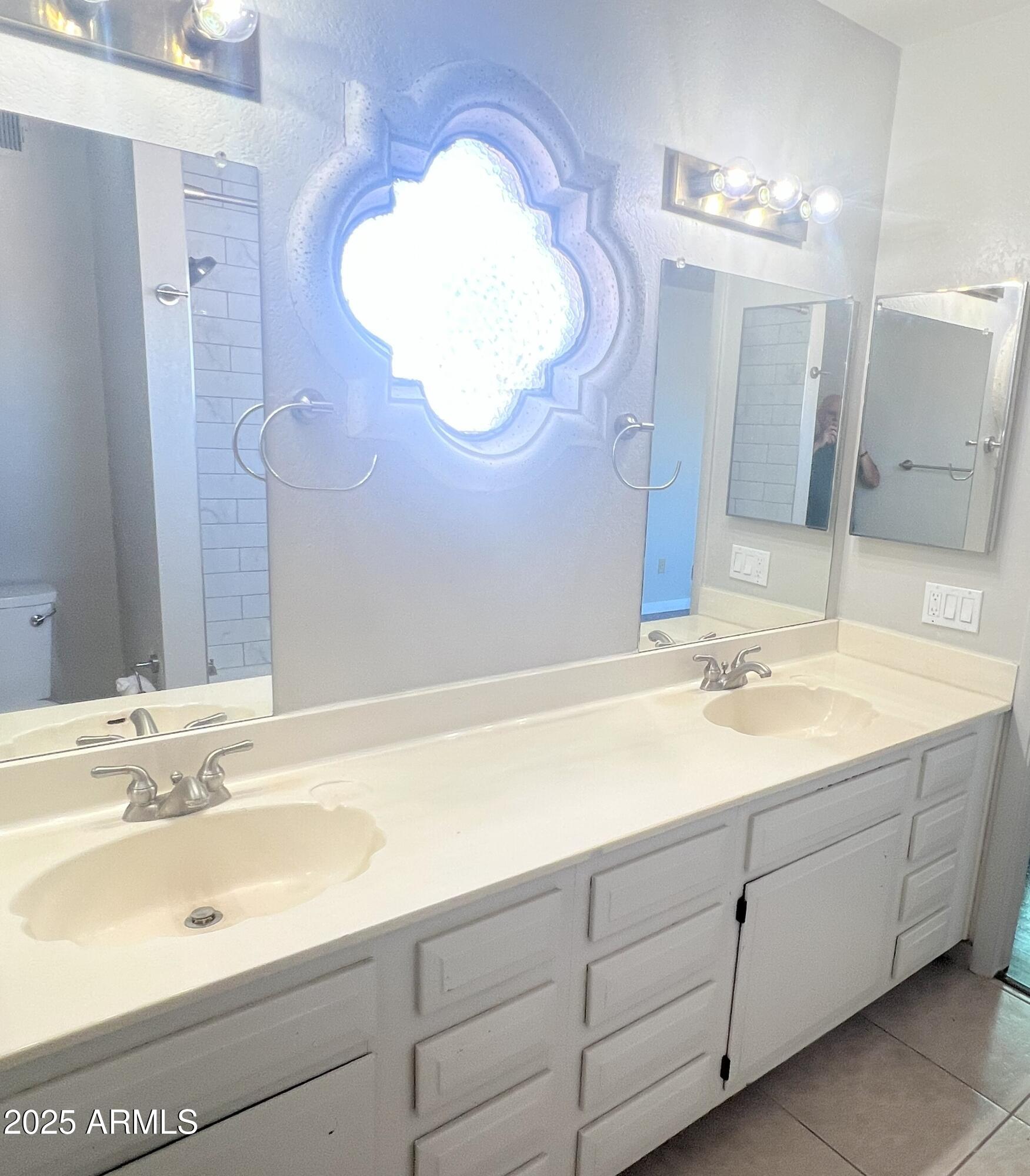 4011 East Charter Oak Road Phoenix, AZ 85032 - Photo 13 of 31 a bathroom with a double vanity sink mirror and