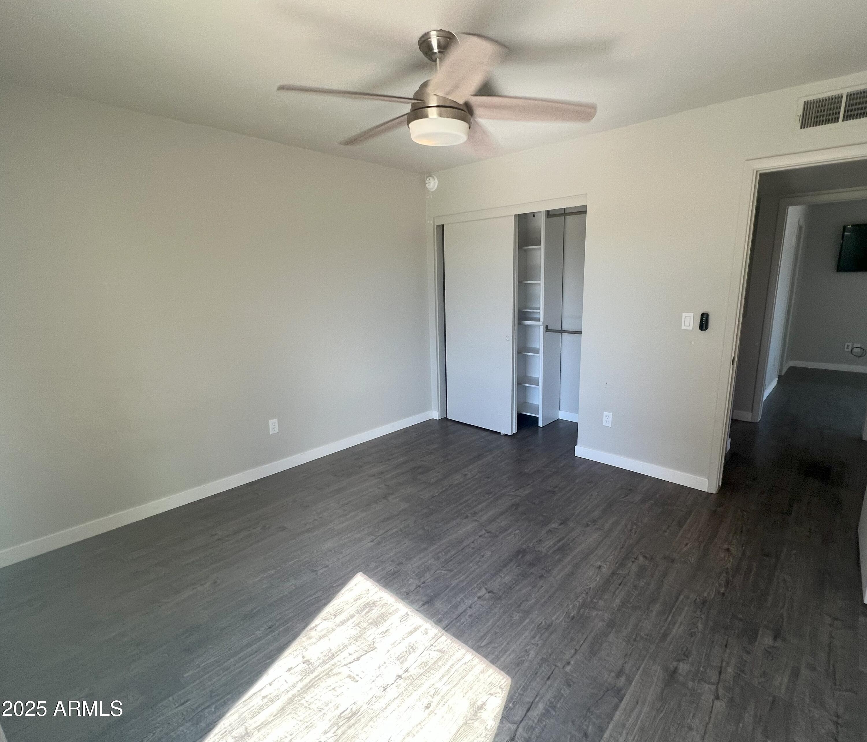 4011 East Charter Oak Road Phoenix, AZ 85032 - Photo 18 of 31 wooden floor in an empty room with a window