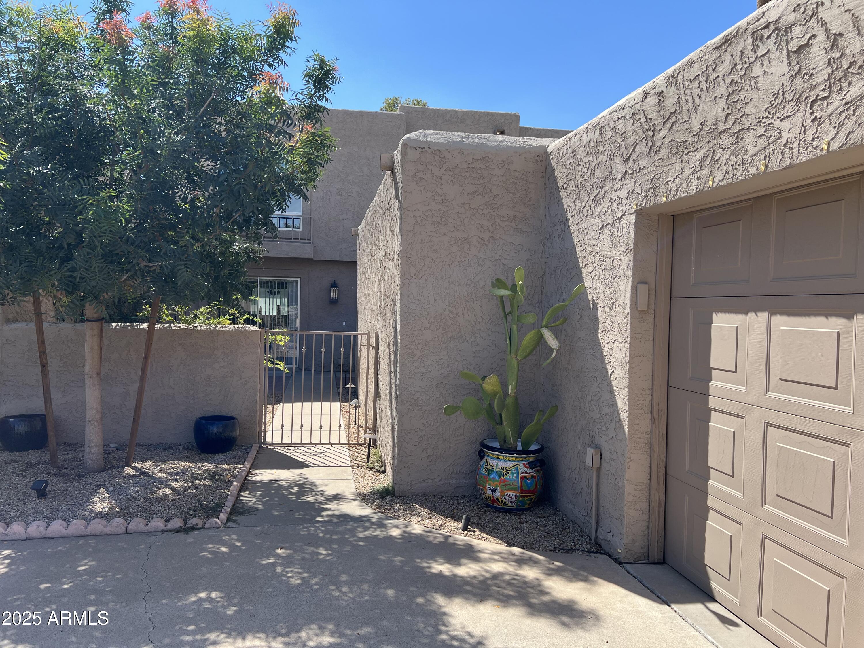 4011 East Charter Oak Road Phoenix, AZ 85032 - Photo 2 of 31 a backyard of a house with table and chairs