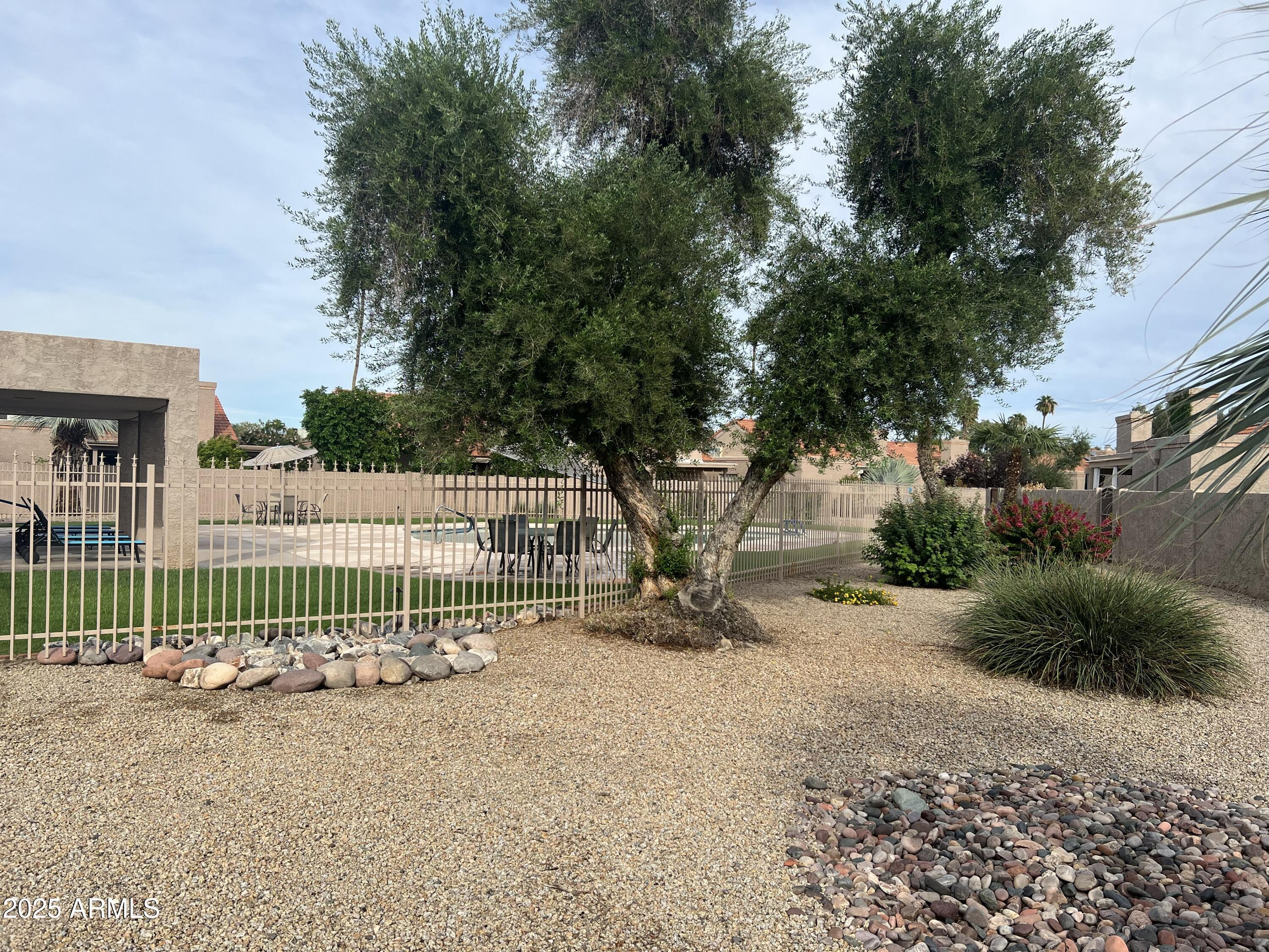 4011 East Charter Oak Road Phoenix, AZ 85032 - Photo 28 of 31 a view of a house with a small yard and fence