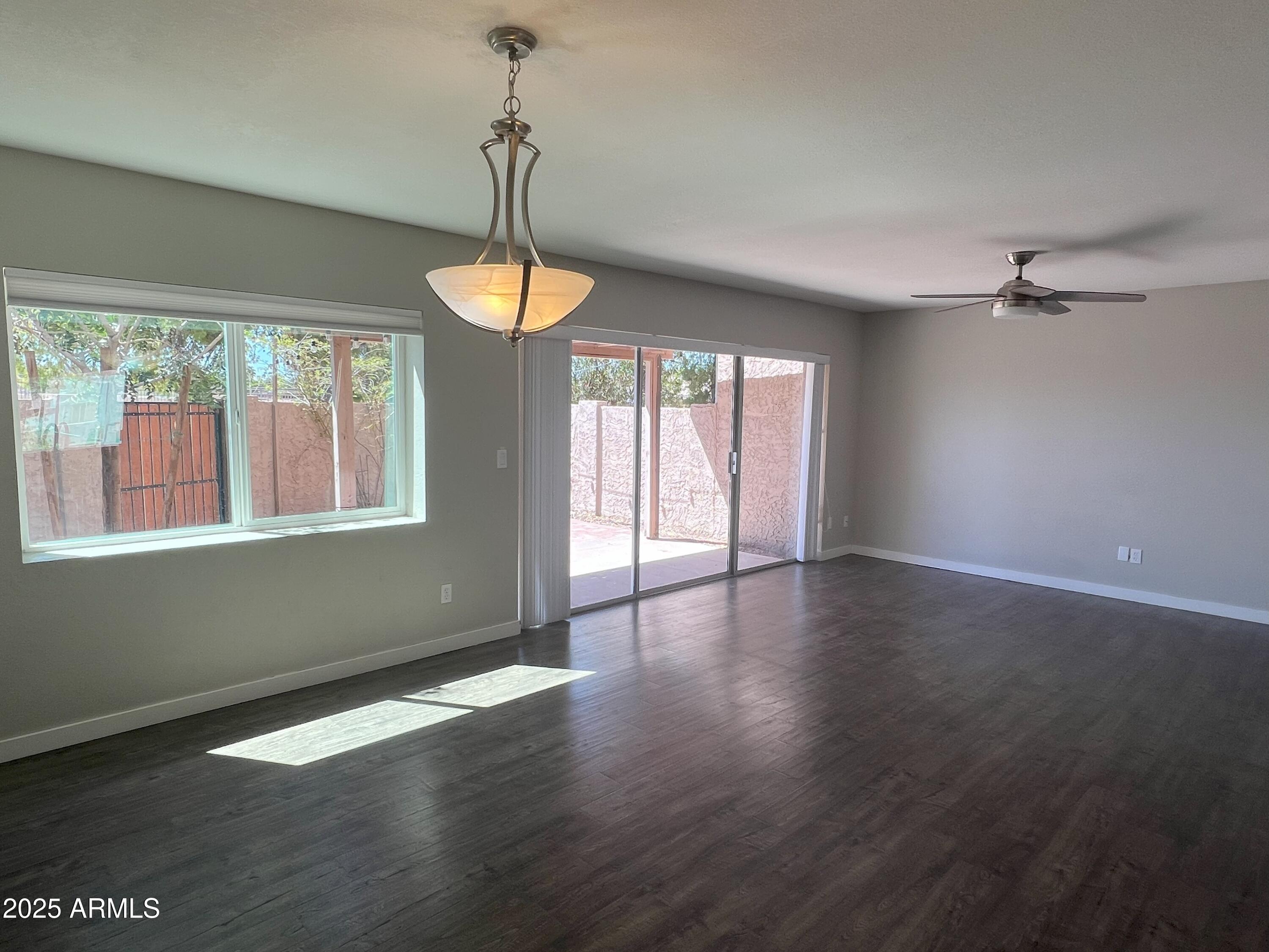 4011 East Charter Oak Road Phoenix, AZ 85032 - Photo 8 of 31 a view of an empty room with wooden floor and a window
