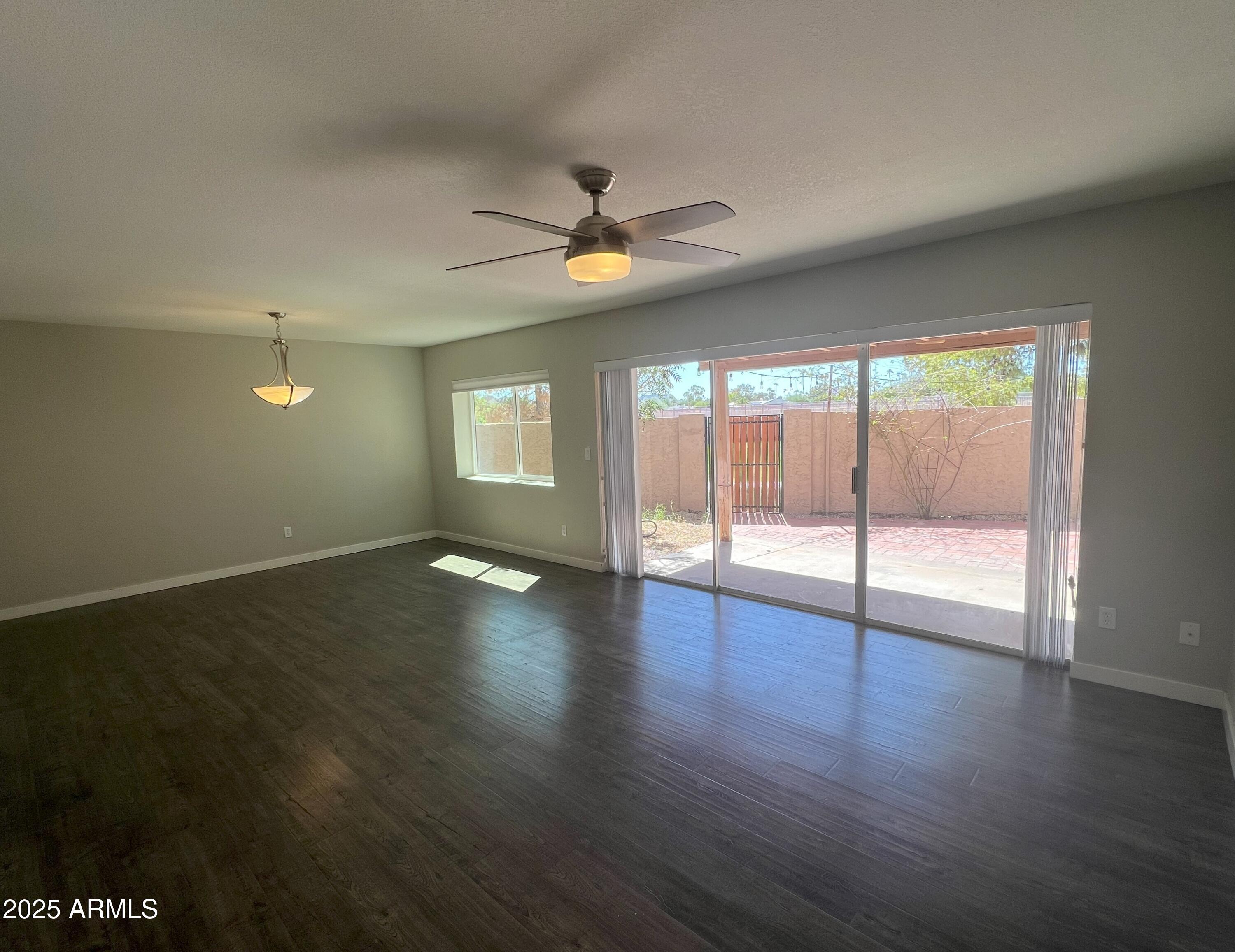 4011 East Charter Oak Road Phoenix, AZ 85032 - Photo 9 of 31 a view of empty room with wooden floor and fan