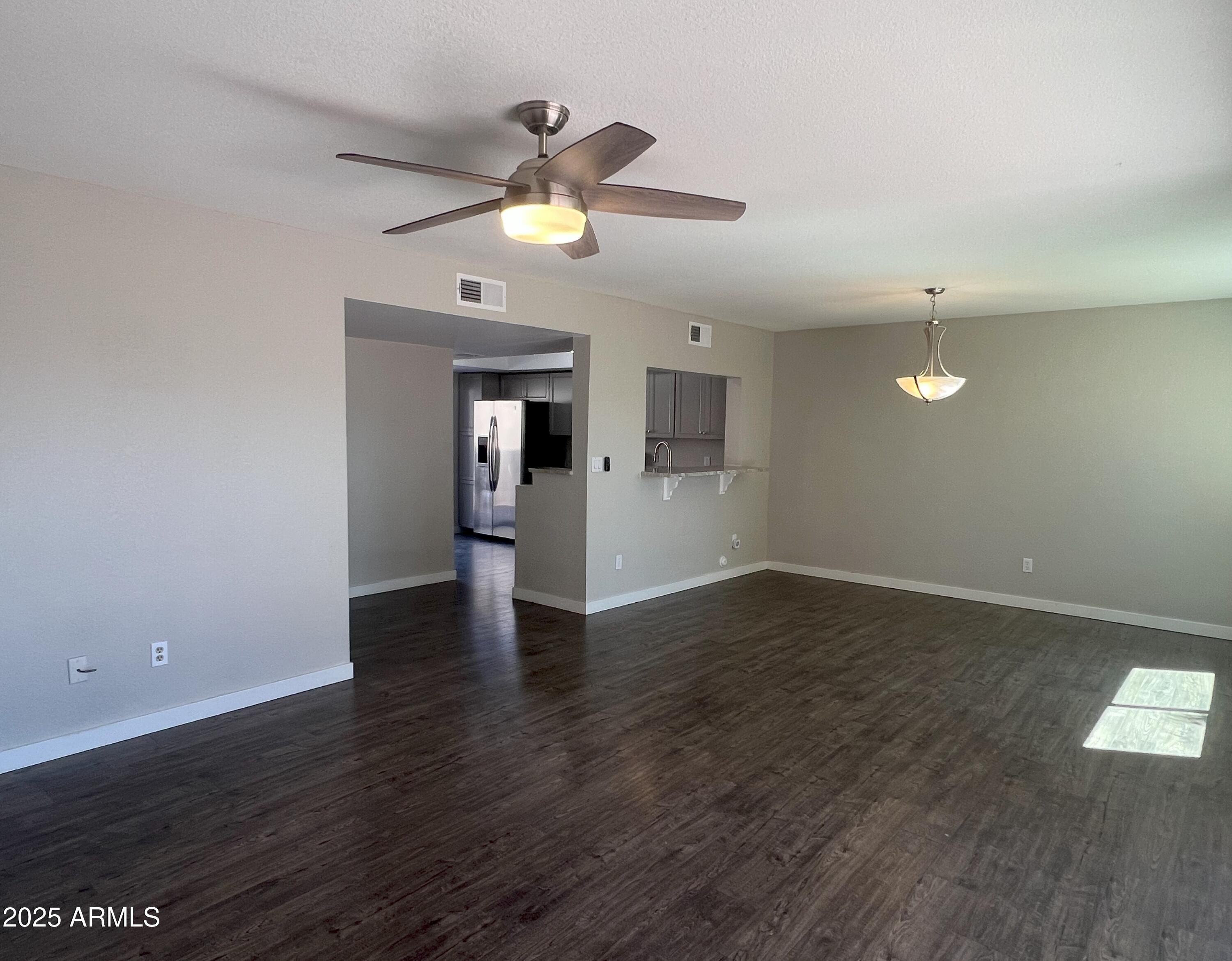 4011 East Charter Oak Road Phoenix, AZ 85032 - Photo 10 of 31 a view of an empty room with window and wooden floor