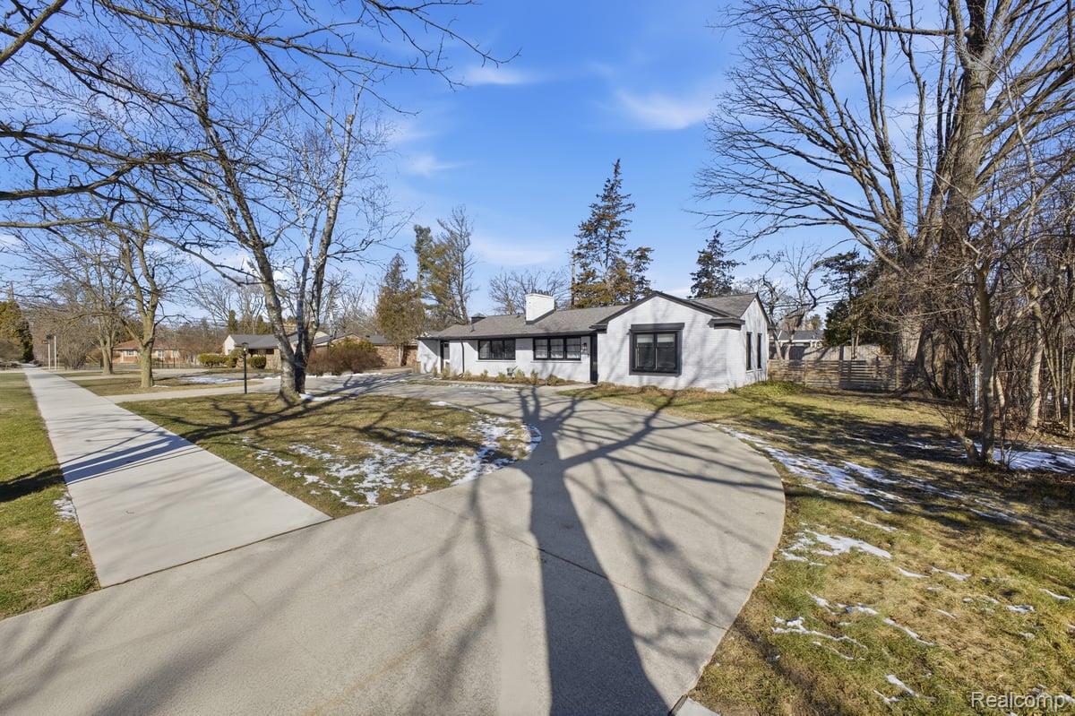 16256 West 13 Mile Road Southfield, MI 48076 - Photo 28 of 30 View of front of house featuring concrete driveway and a chimney