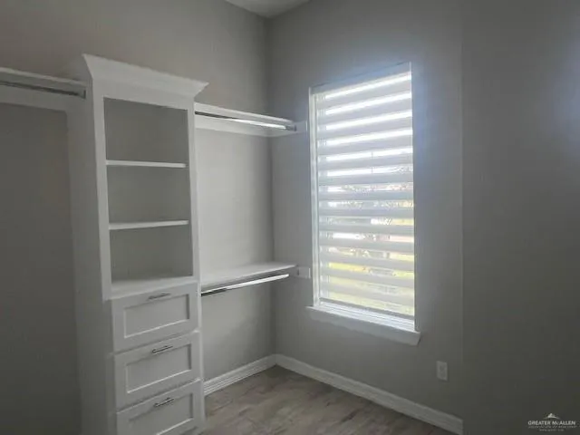 a view of a room with rack on the wall and a window