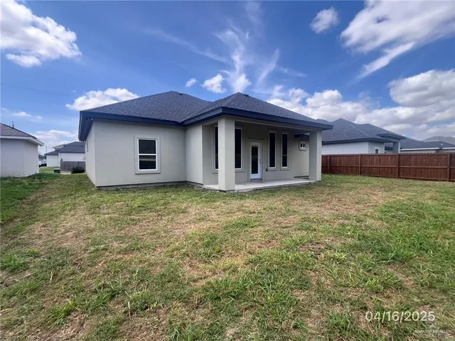a view of a house with a yard and garage