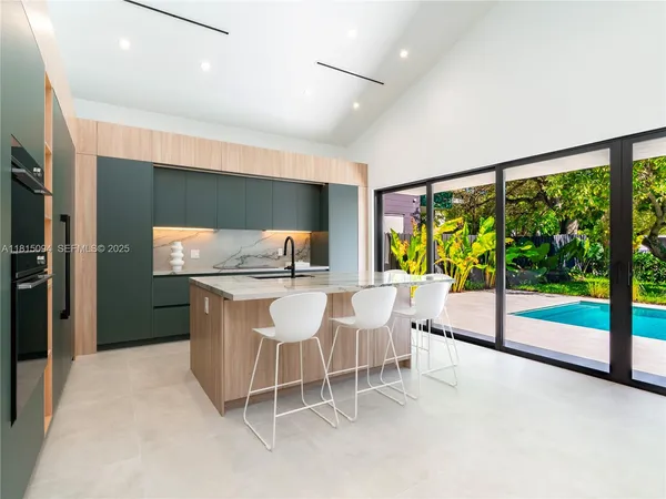a dining room with furniture and a floor to ceiling window