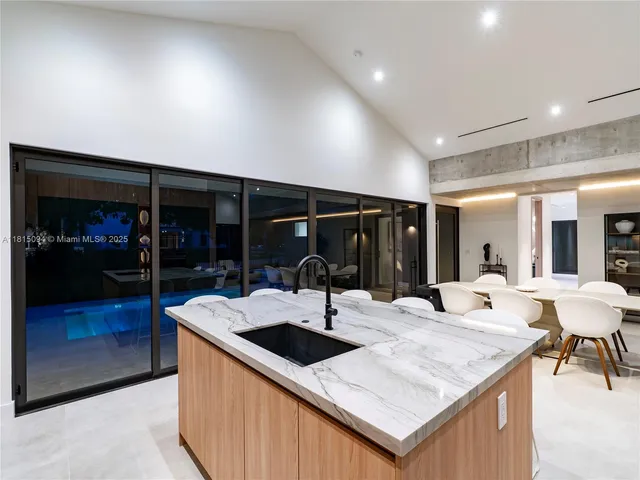 a room with stainless steel appliances kitchen island a sink and cabinets