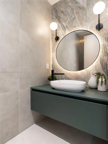 a bathroom with a sink and a mirror