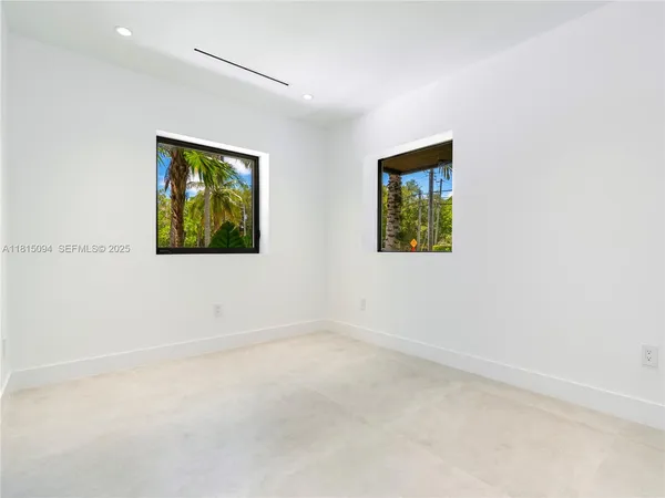 an empty room with a painting on the wall