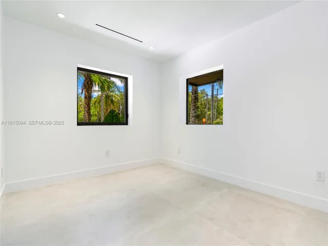 an empty room with a painting on the wall