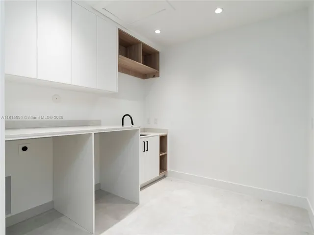 a view of kitchen with sink and microwave